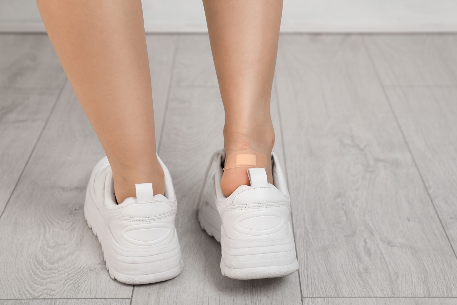 Image female with plastered heel on wooden floor closeu 2026 03 24 22 18 45 utc (1)